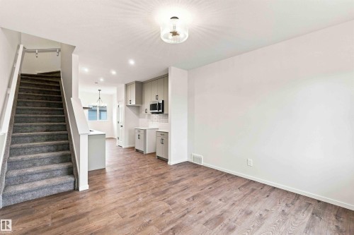 Wood-finish flooring throughout the main level - 7097 Rosenthal Drive Nw, Edmonton, AB 