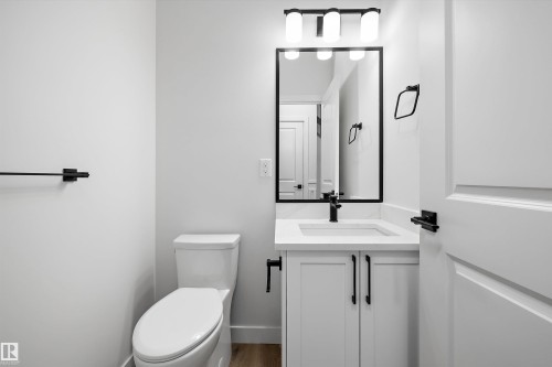 White vanity with a rectangular sink, black faucet, and white countertop - 1780 Crossbill Loop Nw, Edmonton, AB 
