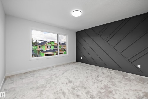 Accent wall with geometric wood paneling, flush mount ceiling light, and light-toned carpeting - 1780 Crossbill Loop Nw, Edmonton, AB 