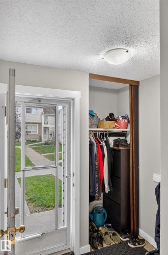 Entryway featuring a built-in closet with shelving and hanging storage - 18319 93 Avenue Nw, Edmonton, AB 