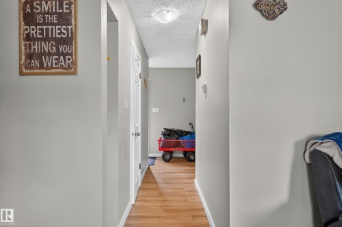 Wood-finish flooring with neutral wall paint and white trim - 18319 93 Avenue Nw, Edmonton, AB 
