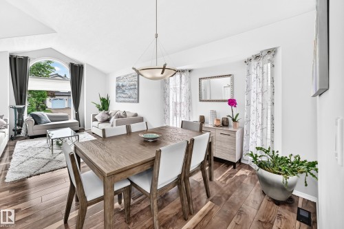 Wood-finish flooring throughout, vaulted ceiling, and an arched window - 4216 47 Street Nw, Edmonton, AB 