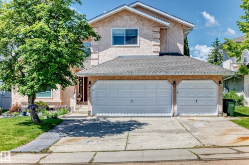 Stucco exterior, two-car attached garage, paved driveway, mature trees, and established landscaping - 4216 47 Street Nw, Edmonton, AB 
