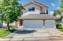 Stucco exterior, two-car attached garage, paved driveway, mature trees, and established landscaping - 4216 47 Street Nw, Edmonton, AB 