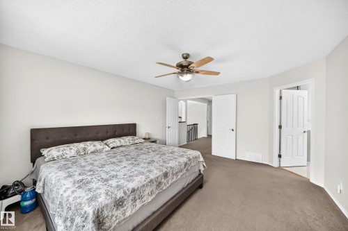 Neutral-toned wall finish, recessed wall alcove, and ceiling-mounted fan with integrated lighting - 4216 47 Street Nw, Edmonton, AB 