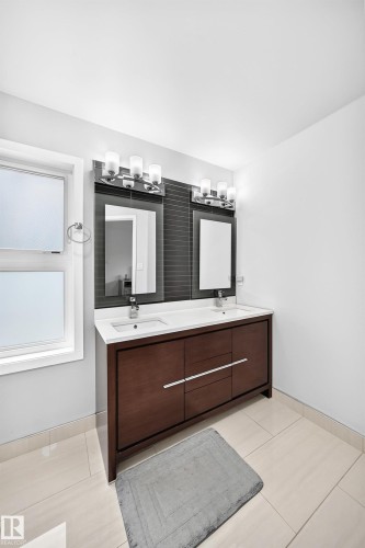 Dual vanity with white countertop, chrome fixtures, and dark wood-finish cabinetry - 4216 47 Street Nw, Edmonton, AB 