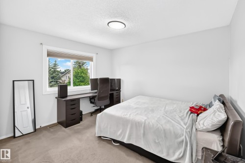 Neutral wall palette, ceiling-mounted light fixture, and window with exterior landscaping visible - 4216 47 Street Nw, Edmonton, AB 