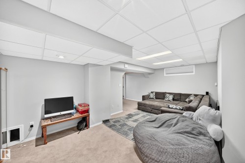 Finished lower level with neutral wall paint and carpet flooring - 4216 47 Street Nw, Edmonton, AB 