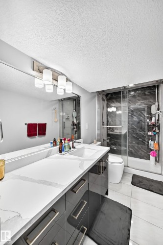 Contemporary vanity with a white countertop and integrated sink - 4216 47 Street Nw, Edmonton, AB 