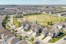 Aerial perspective showcasing a residential development with numerous detached homes, surrounded by green spaces - 2812 12 Street Nw, Edmonton, AB 
