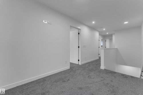 Hallway featuring recessed lighting, light gray carpeting, and white walls - 265 Falcon Crescent, Leduc, AB 