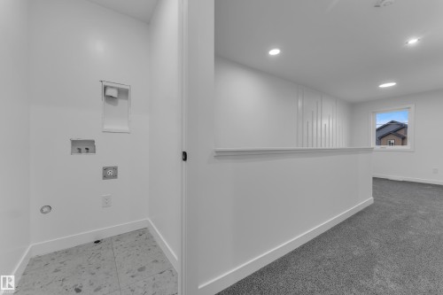 Laundry area featuring tile flooring - 265 Falcon Crescent, Leduc, AB 