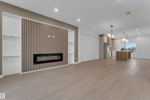 Open-concept floor plan featuring light wood-finish flooring - 265 Falcon Crescent, Leduc, AB 