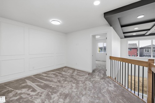 Wainscoting wall paneling, recessed lighting, coffered ceiling, large windows, and carpet flooring - Edmonton, AB 