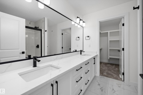 Dual vanity with integrated sinks, matte black fixtures, and quartz countertops - Edmonton, AB 
