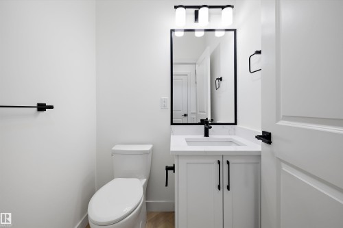 White vanity with a rectangular basin, quartz countertop, and matte black faucet - Edmonton, AB 