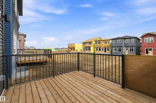 Wood-finish deck with black metal railings - Edmonton, AB 