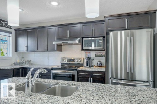 Large granite island and eating bar, SS appliances - 160 Desrochers Gate Sw, Edmonton, AB 