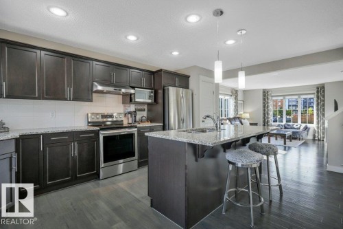 Large granite island with eating bar - 160 Desrochers Gate Sw, Edmonton, AB 