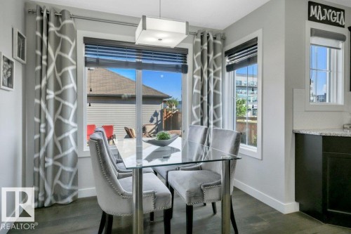 Dining nook overlooking large deck and back yard - 160 Desrochers Gate Sw, Edmonton, AB 