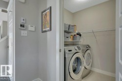 Main floor laundry with ample storage and shelving - 
