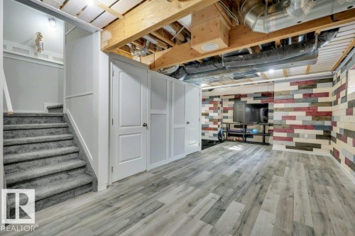 With vinyl plank flooring, wood-slat suspended ceilings and decorative wood plank walls - 160 Desrochers Gate Sw, Edmonton, AB 
