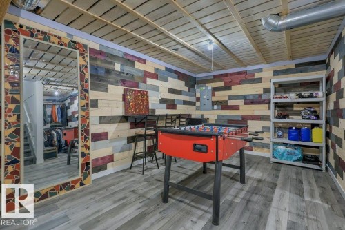 With vinyl plank flooring, wood-slat suspended ceilings and decorative wood plank walls - 160 Desrochers Gate Sw, Edmonton, AB 