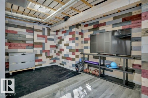 With vinyl plank flooring, wood-slat suspended ceilings and decorative wood plank walls - 160 Desrochers Gate Sw, Edmonton, AB 