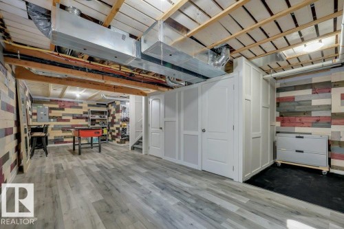 With vinyl plank flooring, wood-slat suspended ceilings and decorative wood plank walls - 160 Desrochers Gate Sw, Edmonton, AB 
