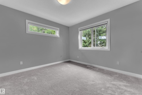 Primary room featuring two windows, including one horizontal transom-style window - 12221 117 Avenue Nw, Edmonton, AB - Indoor Photo Showing Other Room