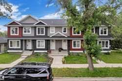 Multi-level townhome featuring a varied facade with gabled rooflines, stone veneer accents, and contrasting siding colors - 