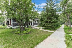 Exterior featuring stone facade detailing, white trim windows, and a prominent front entrance with double white doors - 