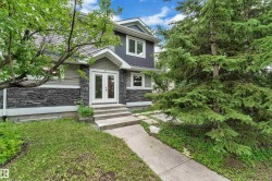 Second front entrance featuring a covered entry porch, white double entry doors, dark stacked stone veneer, and horizontal siding - 
