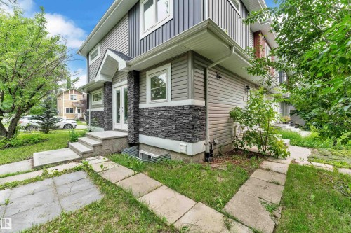 Contemporary exterior featuring multi-toned siding and stone veneer accents - 12221 117 Avenue Nw, Edmonton, AB - Outdoor