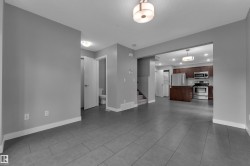 Open concept living space featuring large format grey tile flooring - 