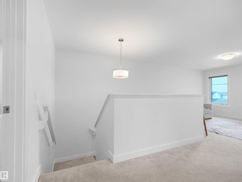 Open upper landing with plush carpeting - 22650 99A Avenue Nw, Edmonton, AB - Indoor Photo Showing Other Room