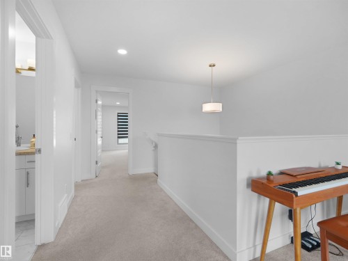 Upper-level hallway featuring neutral carpeting, a contemporary drum pendant light, and recessed lighting - 22650 99A Avenue Nw, Edmonton, AB - Indoor Photo Showing Other Room