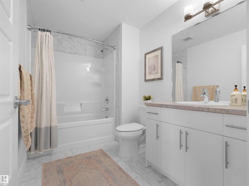 Full bathroom featuring a tub/shower combination with tile surround, a single vanity with a flat-panel cabinet, a rectangular undermount sink, and a framed mirror - 22650 99A Avenue Nw, Edmonton, AB - Indoor Photo Showing Bathroom