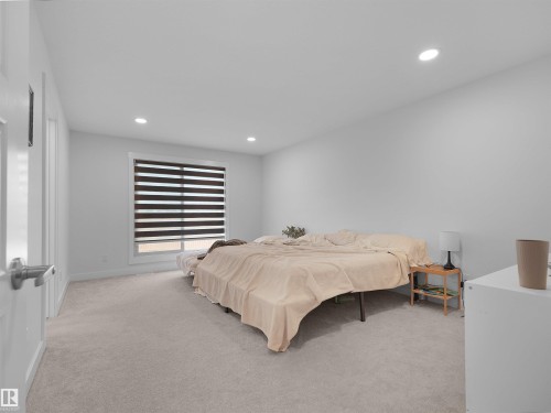 Bedroom featuring recessed lighting, a window with horizontal blinds, light-colored carpeting, and white walls - 22650 99A Avenue Nw, Edmonton, AB - Indoor Photo Showing Bedroom