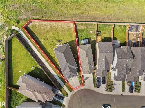 Aerial view highlighting a property with a spacious backyard, concrete driveway, and direct access to a paved walking path - 22650 99A Avenue Nw, Edmonton, AB - Outdoor With View
