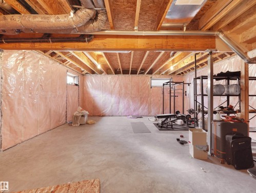Unfinished basement featuring exposed wood joists and subflooring, concrete slab flooring, and insulated perimeter walls - 22650 99A Avenue Nw, Edmonton, AB - Indoor Photo Showing Basement