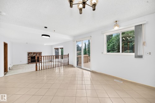 Tiled flooring, sliding glass door with deck access, overlooking living room - 17915 99A Avenue Nw, Edmonton, AB 