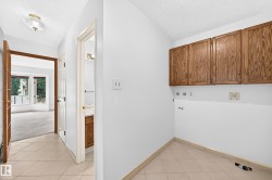 Hallway featuring tile flooring, a semi-flush mount ceiling light, and wood-finish doors - 