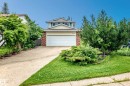 Two-story exterior with a double garage, brick facade, and light-colored siding - 17915 99A Avenue Nw, Edmonton, AB 