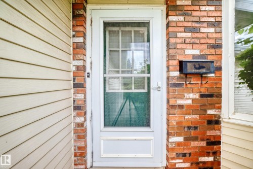 Red brick exterior with light-toned siding - 17915 99A Avenue Nw, Edmonton, AB 