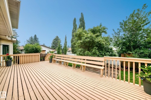 Expansive wood deck with built-in bench seating and sturdy railings - 17915 99A Avenue Nw, Edmonton, AB 