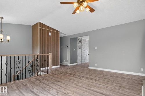 Spacious interior showcasing wood-finish flooring, light gray wall paint, and white baseboards - 9530 174 Avenue Nw, Edmonton, AB - Indoor Photo Showing Other Room