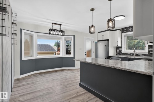 Open-concept kitchen and dining area featuring wood-finish flooring - 9530 174 Avenue Nw, Edmonton, AB - Indoor Photo Showing Kitchen With Upgraded Kitchen