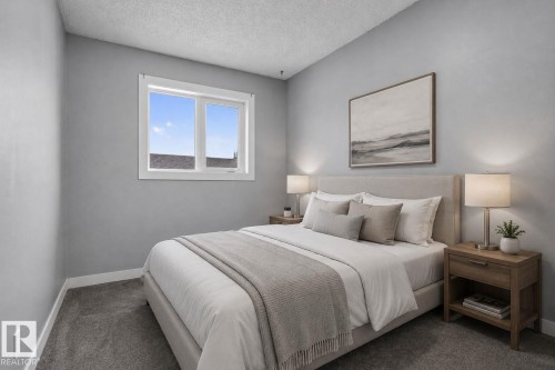 Bedroom featuring a window with white trim, light gray walls, textured ceiling, and gray carpet flooring - 9530 174 Avenue Nw, Edmonton, AB - Indoor Photo Showing Bedroom