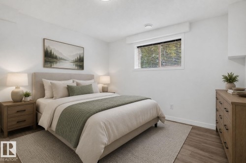 Bedroom featuring wood-finish flooring, a white window frame with horizontal blinds, and recessed ceiling lighting - 9530 174 Avenue Nw, Edmonton, AB - Indoor Photo Showing Bedroom